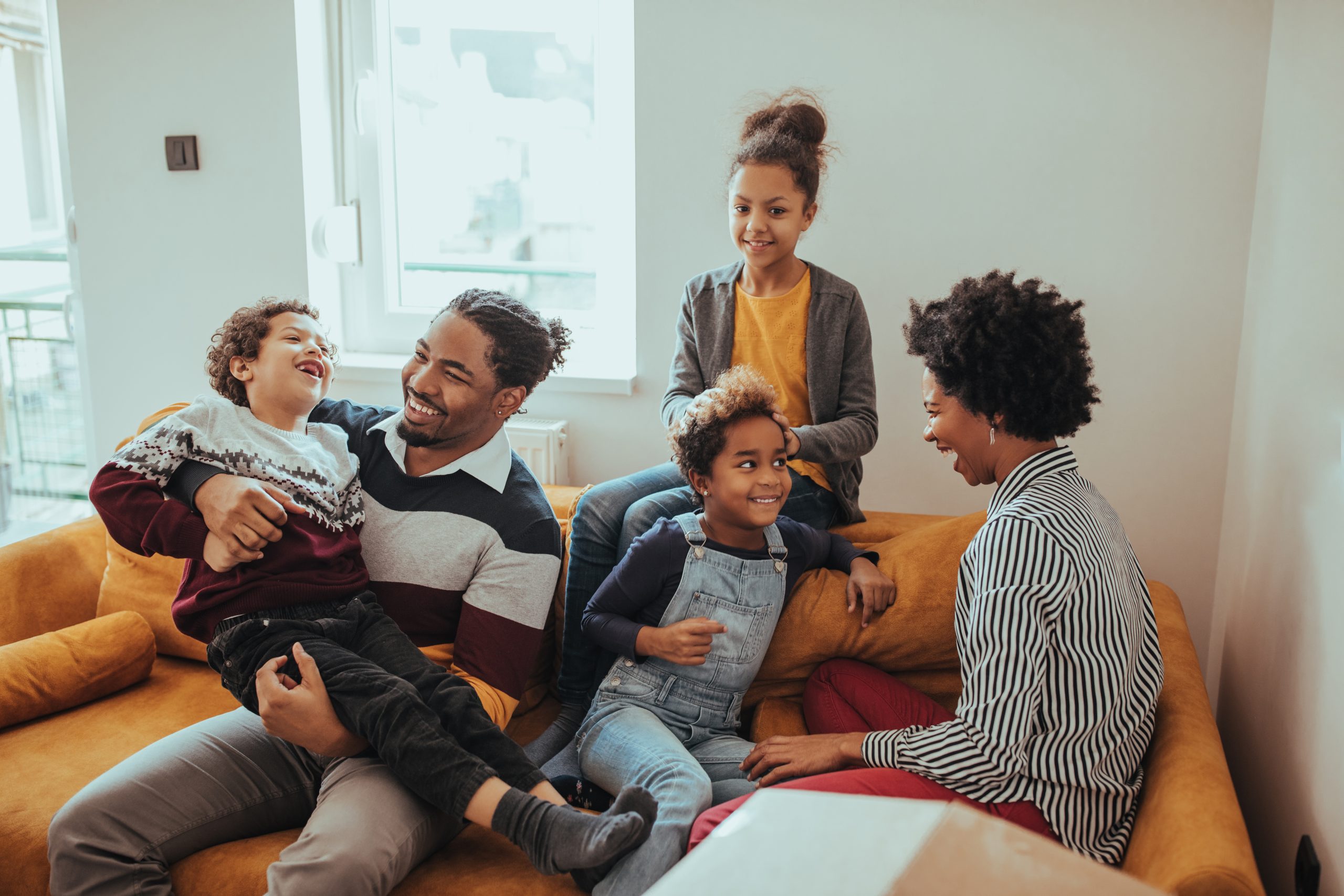 Happy family spending time together in their new home, symbolizing new beginnings with the support of Astraea Linskills Solicitors Liverpool.