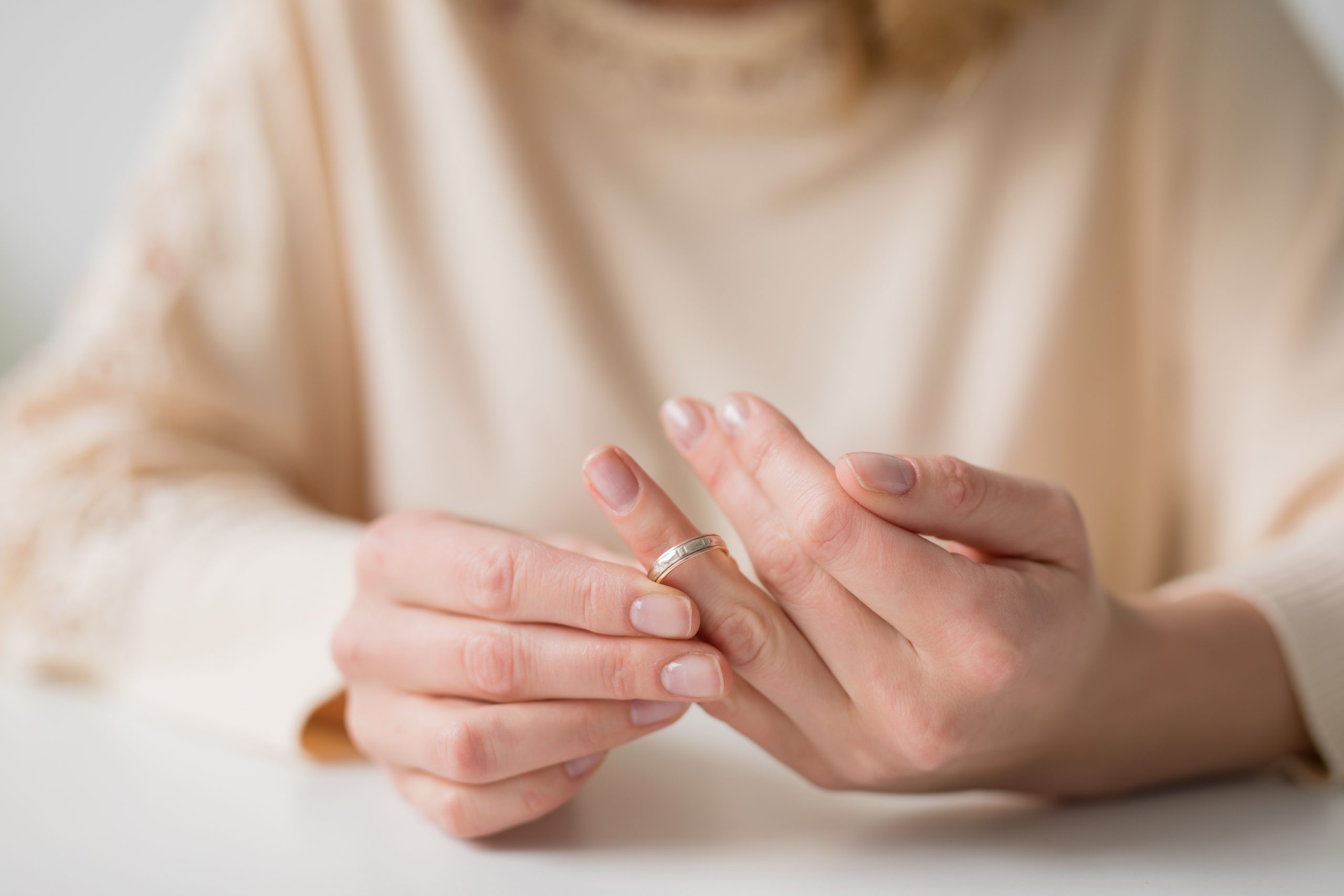 Close-up of a womans hand putting a ring on finger